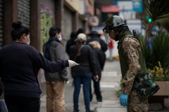 La Paz, Bolivia. 7th Apr 2020. A soldier checks the ID of a woman to make sure that she is entitled to go shopping on that day.